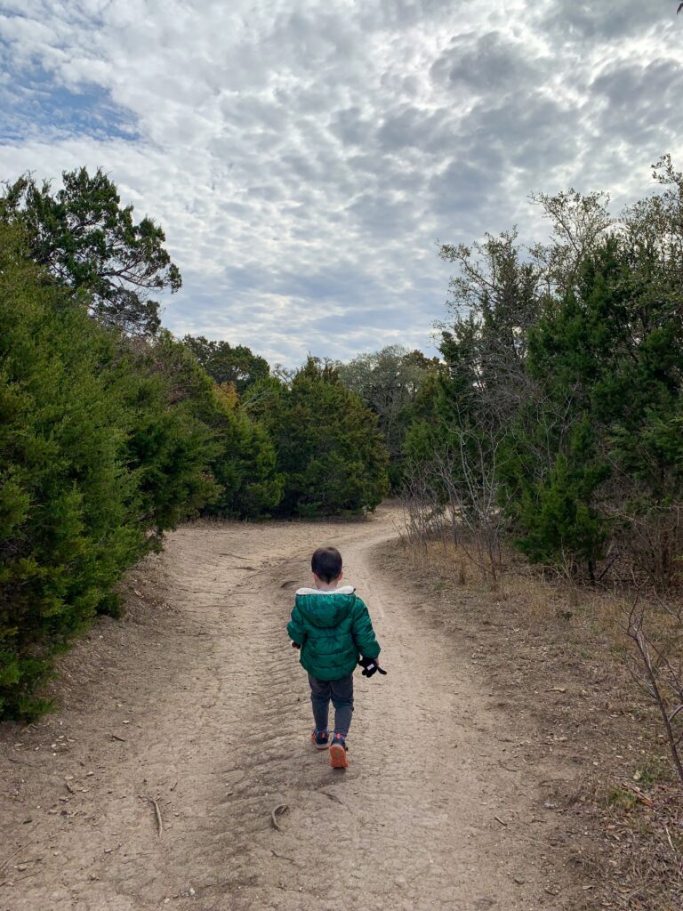 Boy walking down dirt path at Walnut Creek Metro Park