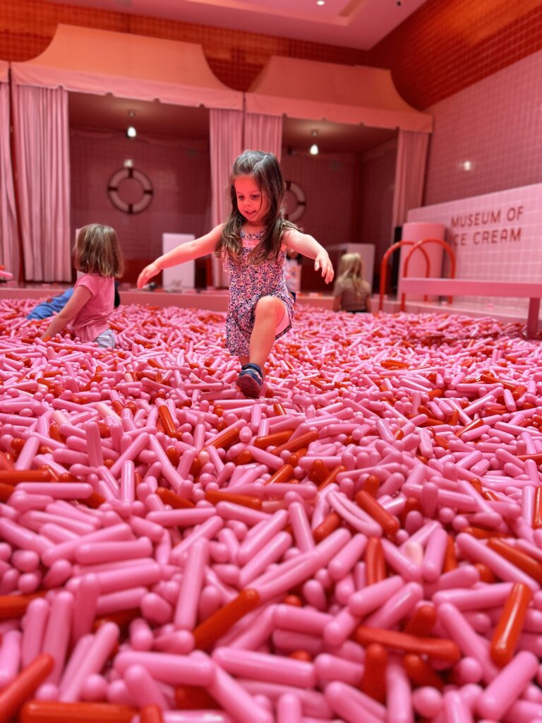 playing in the sprinkle pool at museum of ice cream