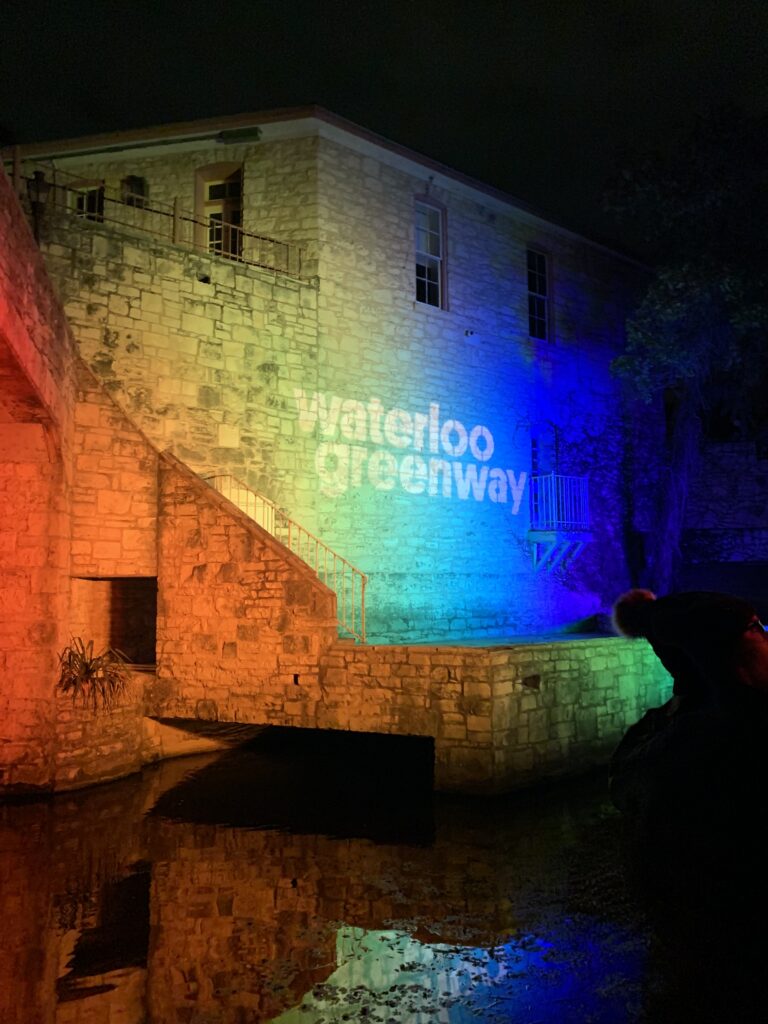 Light-up text that says Waterloo Greenway on the side of a building