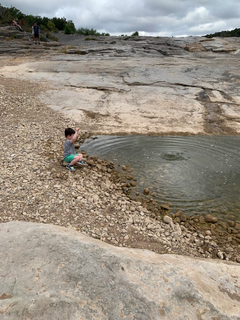 throwing rocks in the Pedernales River